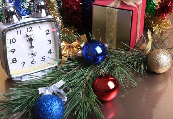 Colored balls , clock and gift boxes on christmas background